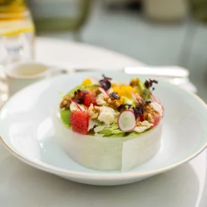 A fresh salad with crab meat, avocado, and citrus fruits.